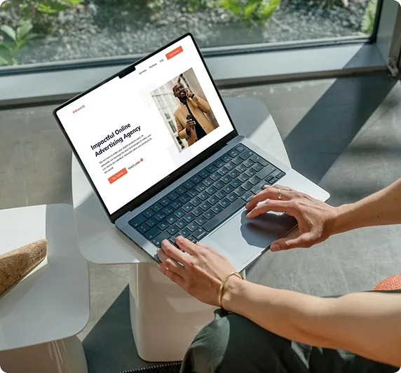 Web designer designing responsive modern marketing agency website on laptop computer